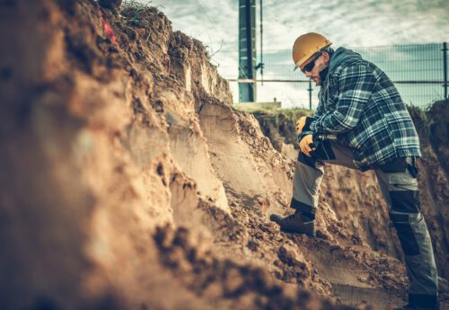 Worker Checking on a Soil